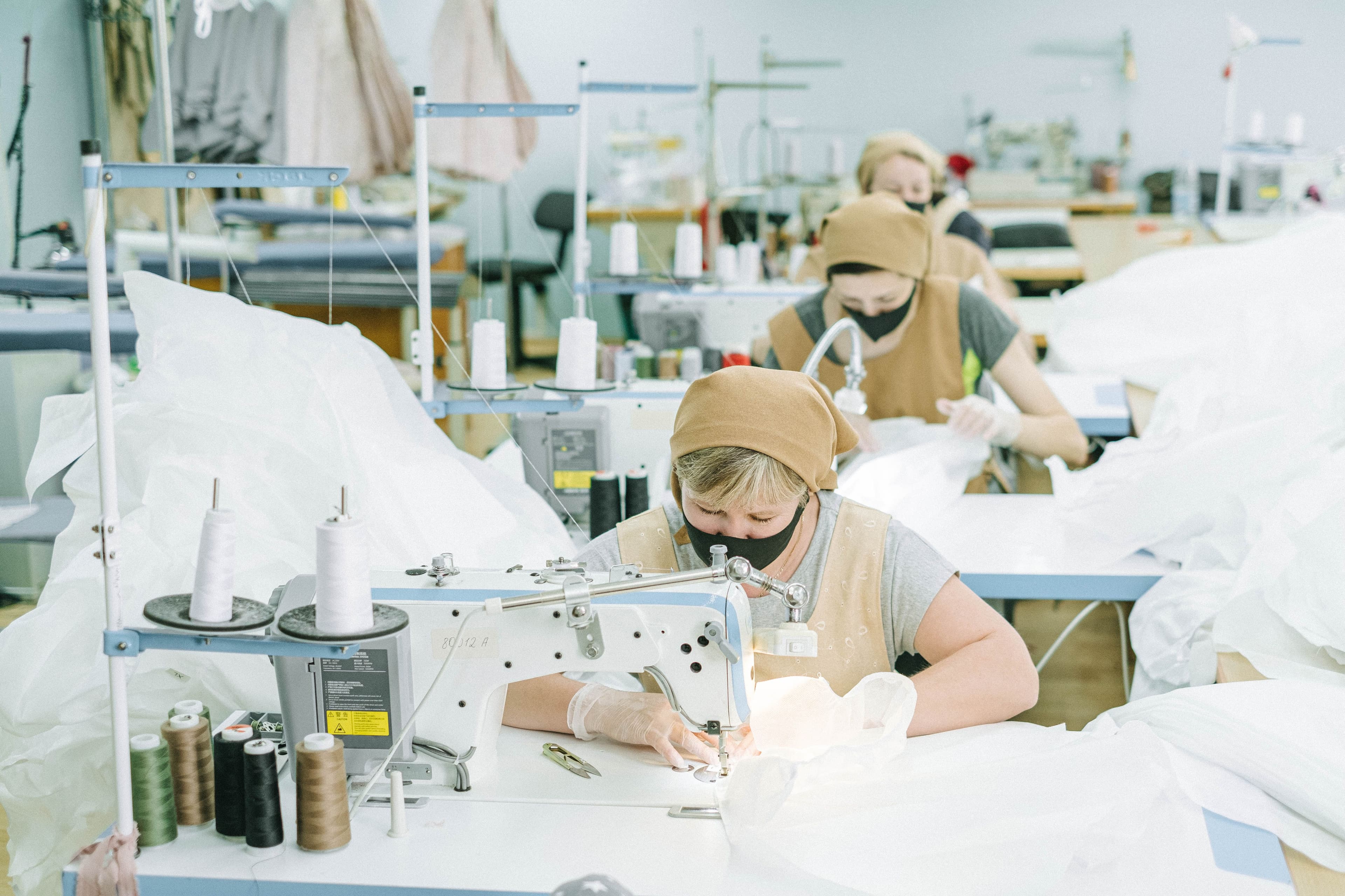 Close view of sewing line work for jacket sample and bulk production control