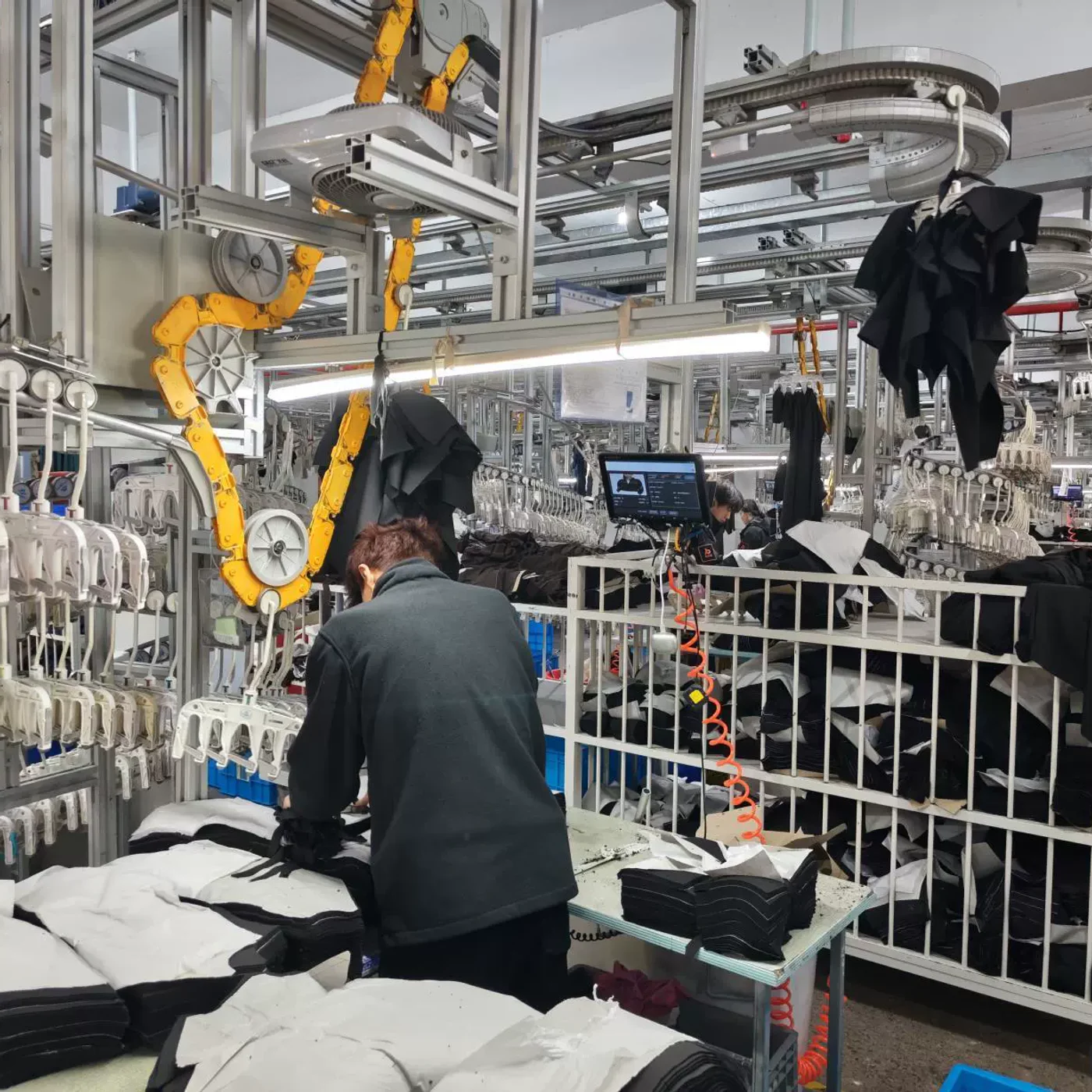 Worker checking garments during production